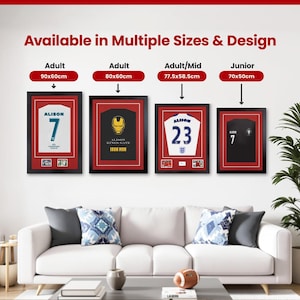 May include: Four framed jerseys, each in a black frame with a red border, are displayed above a white sofa. The jerseys are white, black, and gold, with the text "ALISON" and numbers. The text "Available in Multiple Sizes & Design" is at the top.