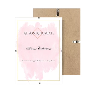 May include: Two picture frames, one in front of the other. The front frame has a white border with gold trim and the text "ALISON KINGSGATE Frame Collection". The background frame is made of light brown wood.