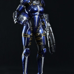 May include: A blue and white action figure of a woman in a futuristic suit, holding a weapon. The figure is standing on a black base.
