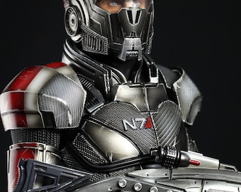 May include: A black and red action figure of a futuristic soldier wearing a helmet with a visor and holding a gun. The soldier's chest armor has the text "N7" printed on it.