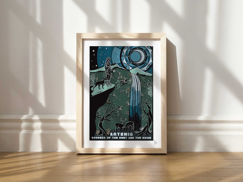May include: A framed print of a stylized illustration of Artemis, the Greek goddess of the hunt and the moon. The image features Artemis standing on a cliff with a dog and a waterfall in the background. The print is in a wooden frame and has a white background.