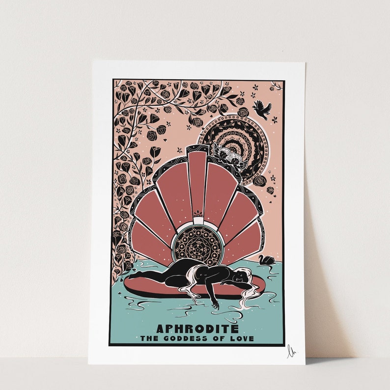 May include: A black and white illustration of the Greek goddess Aphrodite, lying on a seashell. The illustration is surrounded by a pink background with black floral designs. The text "APHRODITE THE GODDESS OF LOVE" is at the bottom of the image.