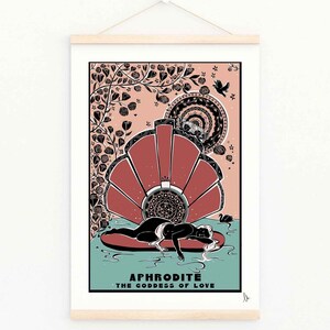 May include: Aphrodite, the Goddess of Love, is depicted in a black and white illustration. She is lying on a seashell in a body of water. The background is a peach colour with black floral designs and a bird.