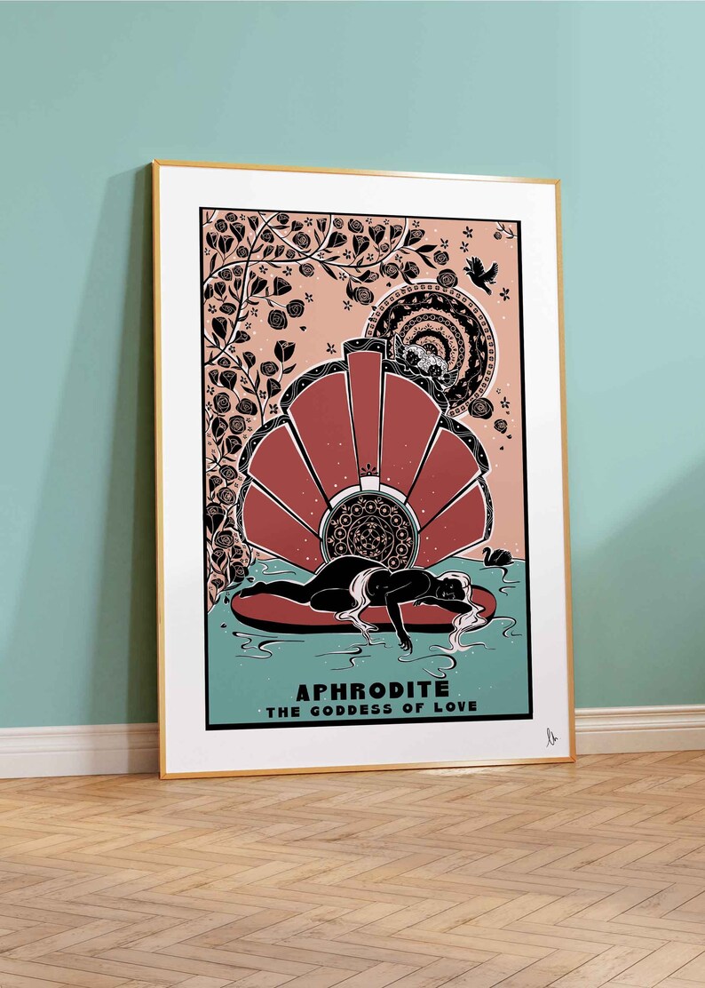 May include: Aphrodite, the Goddess of Love, is depicted in a black and white illustration with a red and white shell behind her. The illustration is surrounded by a floral design with a pink background.