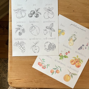 May include: Two printable sheets with black and white line drawings and watercolor illustrations of fruit and berries. The text "galatians 5:22-23" is at the top of each sheet. The words "love, joy, peace, patience, kindness, goodness, faithfulness, gentleness, self-control" are listed on each sheet.