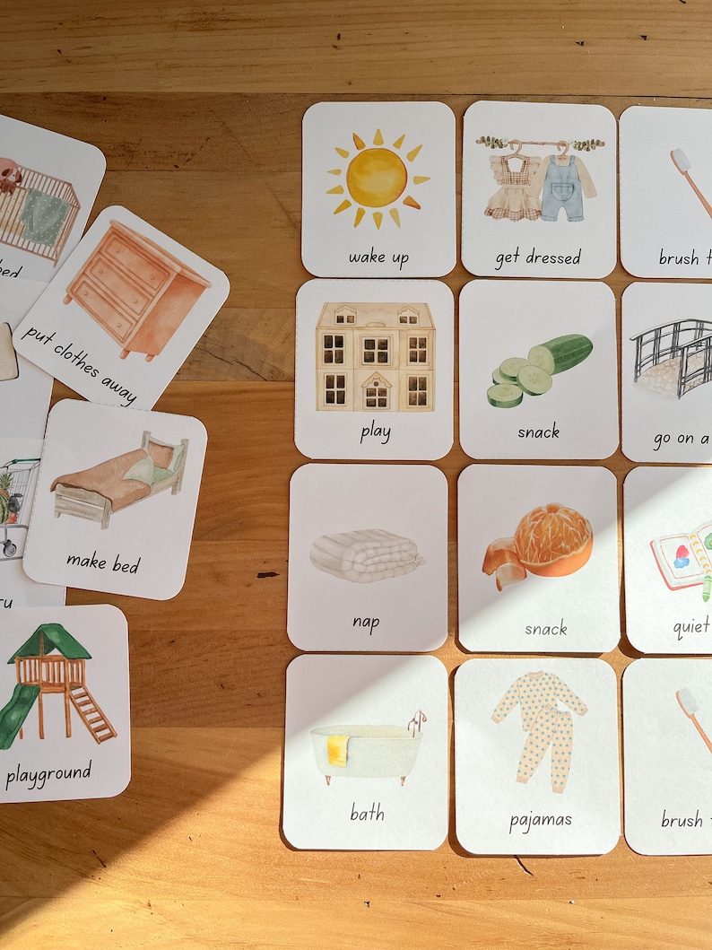 May include: A set of 16 illustrated cards with various activities for children. The cards feature images of a sun, a bed, a bathtub, a playground, a house, a toothbrush, a cucumber, a bridge, a dresser, a stack of clothes, a stack of towels, an orange, a book, and pajamas. Each card has a word written below the image.