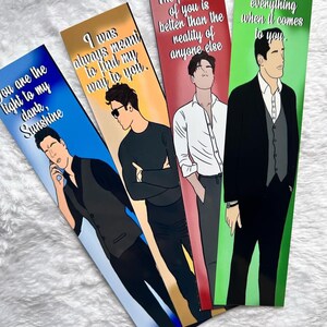May include: Four bookmarks with illustrations of men and romantic quotes. The bookmarks have a gradient background of blue, gold, and red. The quotes include "You are the light to my dark, Sunshine" and "I was always meant to find my way to you."