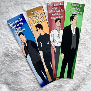 May include: Four rectangular bookmarks with illustrations of men and romantic quotes. The bookmarks have a blue, gold, red, and green background. The quotes include "You are the light to my dark, Sunshine" and "I was always meant to find my way to you."