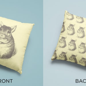 May include: A decorative pillow with a chinchilla illustration. The front of the pillow features a detailed pencil drawing of a chinchilla. The back of the pillow has a repeating pattern of chinchilla drawings. The pillow is a light yellow color.