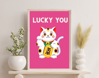 May include: A pink and white printable art print featuring a cartoon lucky cat with the text "LUCKY YOU" in white.