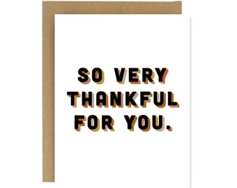 May include: A white card with the text "SO VERY THANKFUL FOR YOU." in black letters with a layered orange, yellow, and red background.