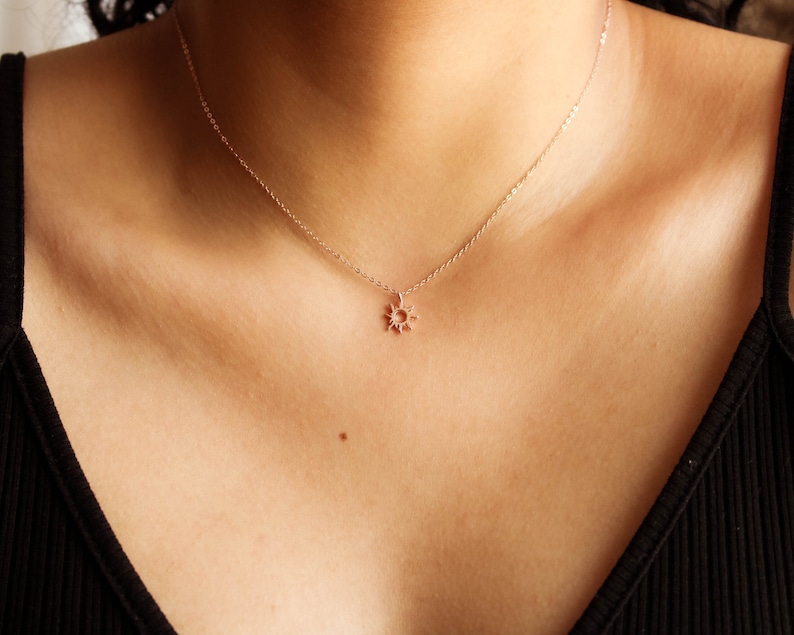 An elegant and minimalist sun necklace crafted from sterling silver with rose gold finish. This dainty piece of jewelry is perfect for daily wear or special occasions, adding a touch of warmth and radiance to any outfit.