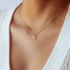 Featuring yellow gold plated minimalist sun pendant on delicate sterling silver rolo chain.