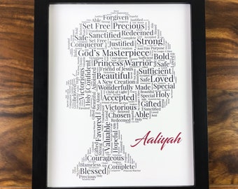 May include: A black and white word cloud in the shape of a heart with the name "Aaliyah" in red at the bottom. The words in the cloud are positive and uplifting, such as "blessed", "safe", "loved", "hopeful", "victorious", "chosen", "gifted", "friend of Jesus", "princess warrior", "masterpiece", and "God's masterpiece".