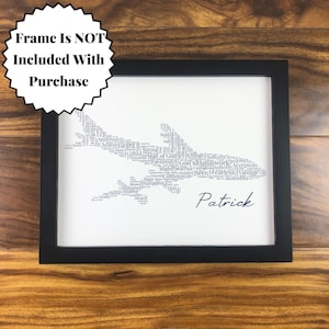 Word art with words in the shape of an airplane in gray color. Black name printed below airplane. The words in the print remind him of identity in Christ - God’s handiwork, valuable, loved, forgiven, etc.