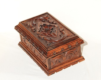 Jewelry box with secret locking system and hand carved accents. No key required. Secret auto-locking feature. Velvet inlay interior options