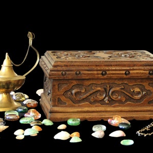 Puzzle box for adults with 17 secret sequential steps to access the secret compartment and a hidden key in a secret compartment. Lock box