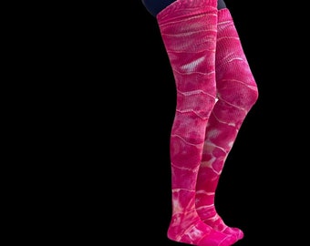 May include: A pair of pink thigh-high socks with a white tie-dye pattern.