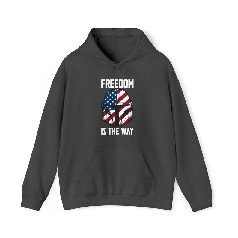 May include: Dark gray hoodie with a front graphic featuring a helmet design incorporating the American flag. The text "FREEDOM IS THE WAY" is printed above and below the helmet design in white block letters. The hoodie has a drawstring hood and a front pocket.