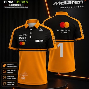 May include: A black and orange McLaren Formula 1 team polo shirt featuring sponsor logos including Dell Technologies, Android, OKX, and Mastercard. The front displays a signature and LN1, while the back features the number 1 and Mastercard branding.
