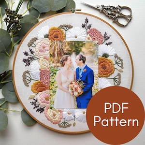 May include: Embroidered hoop art featuring a floral design in shades of pink, white, and orange surrounding a framed photograph of a couple. The text "PDF Pattern" is displayed on a brown circle.
