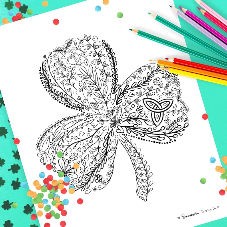May include: A black and white printable coloring page featuring a detailed illustration of a shamrock with intricate floral designs and a Celtic knot. The shamrock is surrounded by colorful confetti.