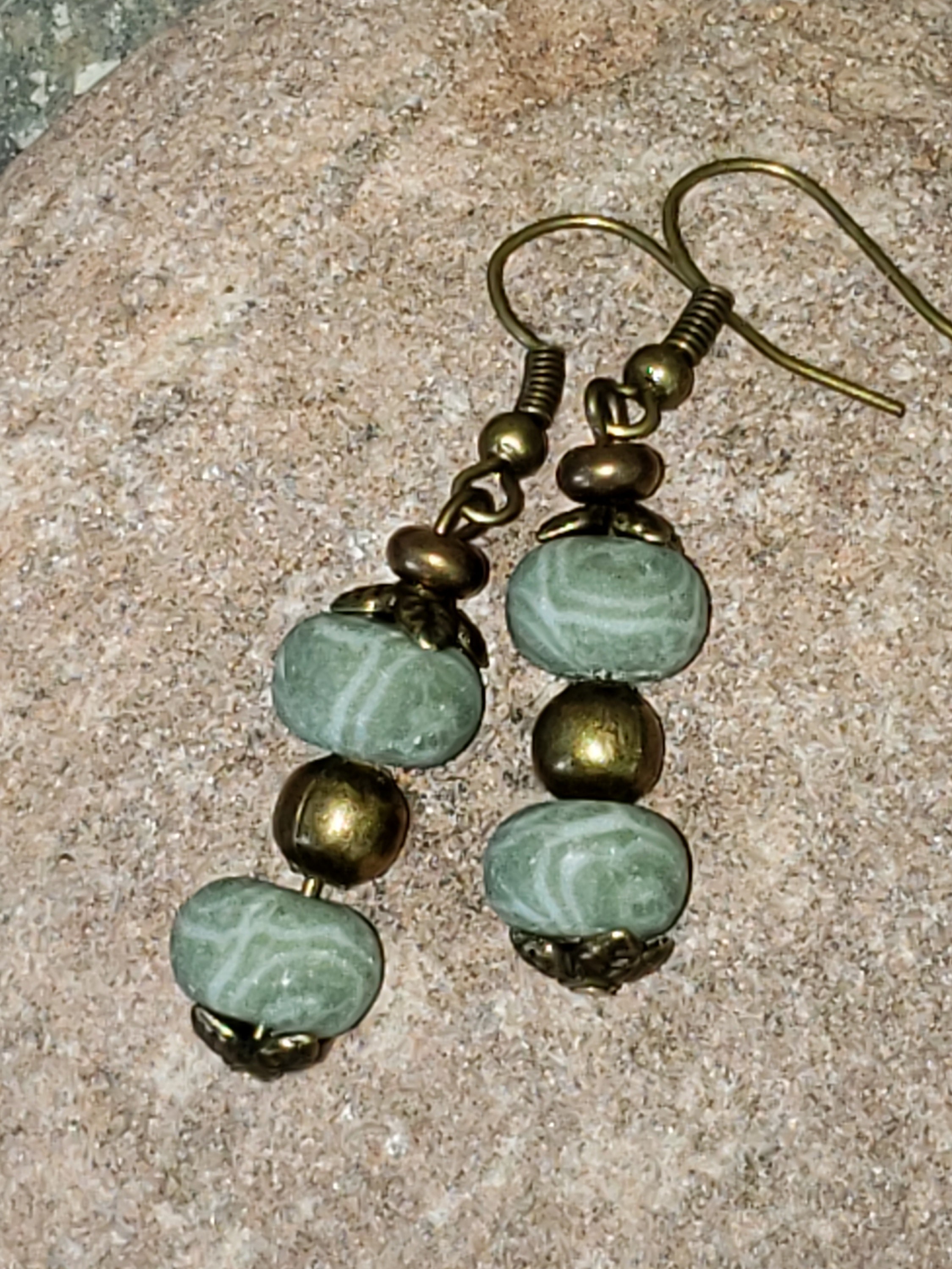 Beaded earrings in clay beads. Soft green with bronze accent Etsy