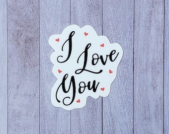 May include: White sticker with the text "I Love You" in black cursive font. The sticker is surrounded by small red hearts.
