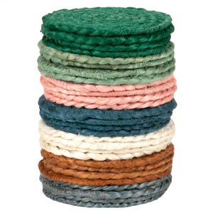 May include: A stack of round woven coasters in various colors, including green, blue, pink, white, brown, and gray.