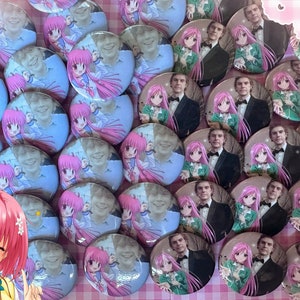 May include: A collection of round buttons featuring a photo of a man with an anime character. The buttons are arranged in a grid pattern on a pink and white checkered background. The anime character has pink hair and is wearing a green and white dress.