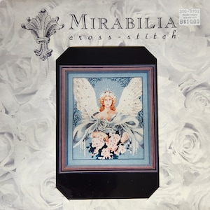 May include: A cross-stitch pattern featuring a blue-toned angel with a crown and a bouquet of pink flowers. The pattern is framed in black and has the title "MIRABILIA cross-stitch" and the number "300-9703".