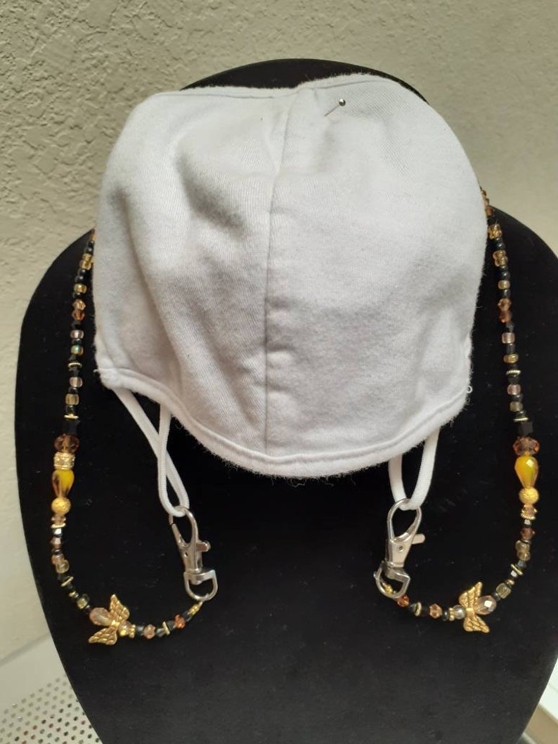 Handmade gold Angel beaded mask holder.