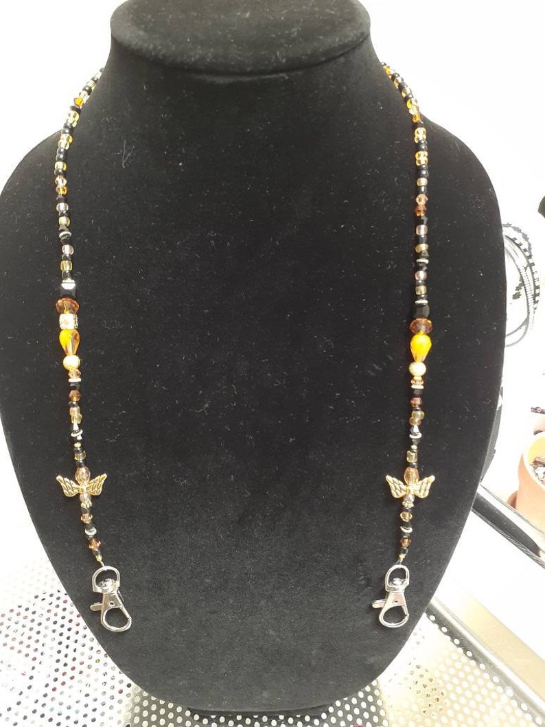 Handmade gold Angel beaded mask holder.