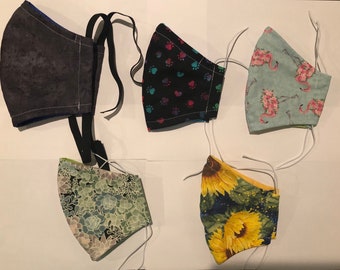 Herbruikbare stoffen gezichtsmaskers met nieuwe stofpatronen