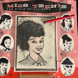 May include: Vintage "Miss Teenie" toy set. The packaging is pink and red with illustrations of women's faces. The set includes a mirror and a red pencil for creating hairstyles. Text on the packaging reads "Create Your Own Hair Styles for Miss Teenie!"