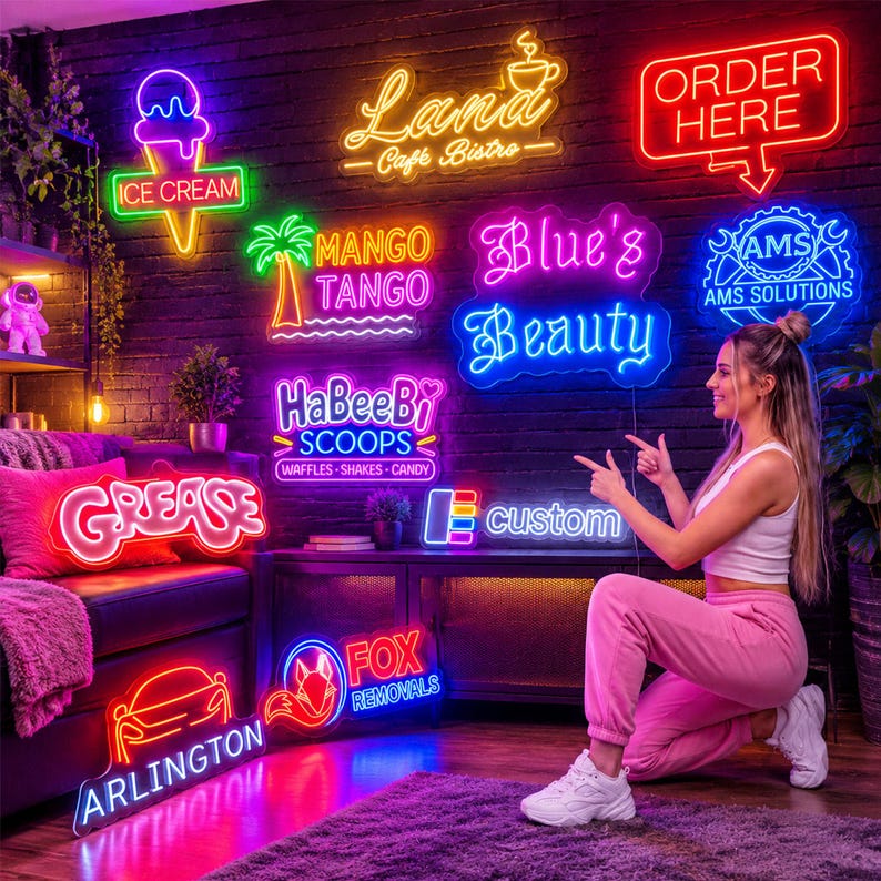 May include: A collection of various neon signs mounted on a dark brick wall, featuring text and graphics including an ice cream cone, a palm tree, the words Lana Cafe Bistro, Order Here, Blue's Beauty, HaBeeBi Scoops, Grease, and Fox Removals.