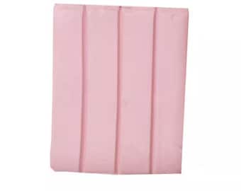 May include: A pink rectangular bar of soap with three raised lines.
