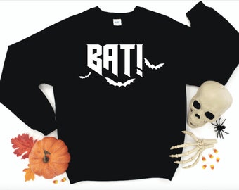 May include: Black sweatshirt with white text that says "BAT!" and a few bats around the text.