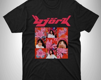 May include: Black t-shirt with a pink and red graphic of the word "Björk" and a collage of images of Björk with pink flowers.