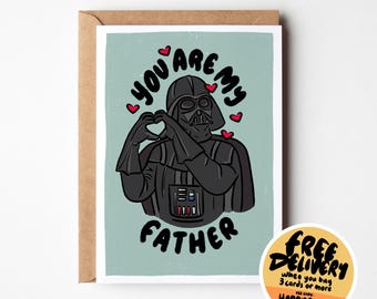 May include: Greeting card featuring Darth Vader making a heart shape with his hands. The text reads "YOU ARE MY FATHER" with red hearts. The card is on a brown envelope.