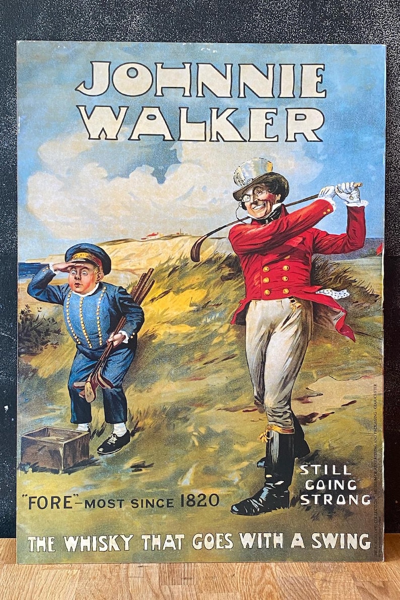 May include: Vintage Johnnie Walker whisky advertisement featuring two figures on a golf course. The text reads "Johnnie Walker" and "Fore-most since 1820." The image has a blue sky background and a golf theme.
