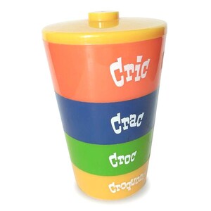 Peut inclure: Un récipient en plastique jaune, orange, bleu et vert avec un couvercle. Le récipient porte les inscriptions "Cric", "Crac", "Croc" et "Croquant".