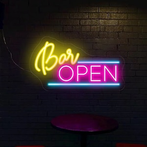 May include: Neon sign with the words "Bar Open" in yellow and pink lettering on a brick wall background.