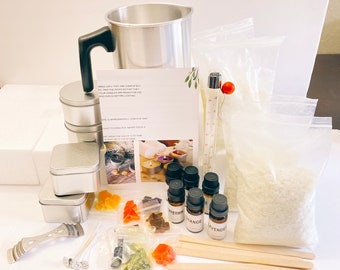 May include: A candle-making kit with a metal melting pot, tins, essential oils, wax, wicks, and a thermometer. The kit includes instructions and various colorful additives for creating scented candles.