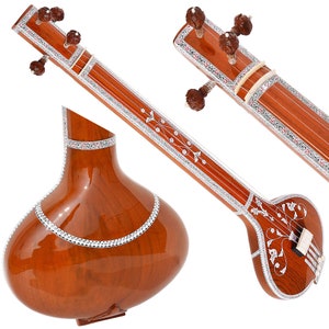 May include: A brown wooden sitar with silver inlay and a pear-shaped body. The sitar has a long neck with tuning pegs and a bridge.