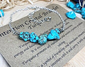 May include: Turquoise crystal bracelet with a silver chain. The card reads "Intention Crystal Bracelet Turquoise" and describes the properties of turquoise.