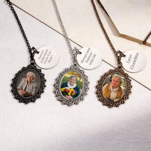 May include: Three oval pendant necklaces with photos of women. Each pendant has a decorative frame and a chain. One pendant says "Forever in My Heart I Love You Mom!", another says "Always and Forever with Me", and the last says "Love Grandma".