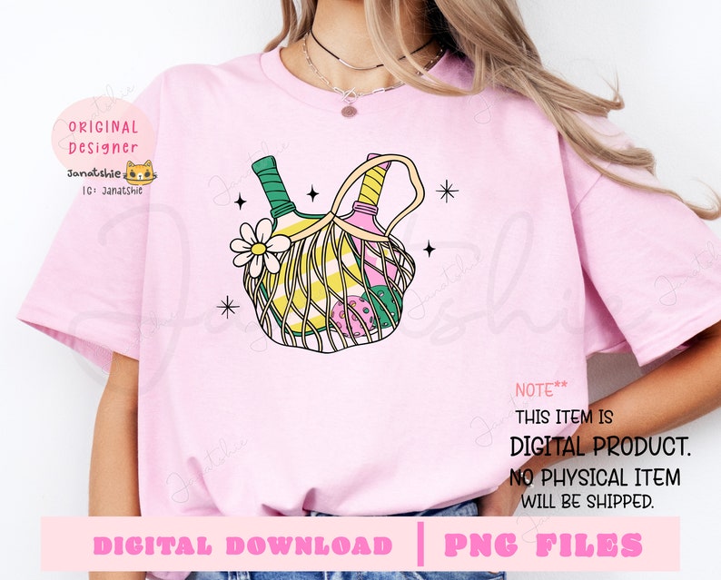 May include: A pink t-shirt with a graphic of two bottles of wine in a green and yellow wicker basket with a pink flower. The text "NOTE** THIS ITEM IS DIGITAL PRODUCT. NO PHYSICAL ITEM WILL BE SHIPPED." is printed on the shirt.