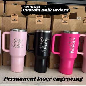 Premium personalized 40oz Stanley tumblers with high-definition laser-engraved logos and names. A clean, minimalist display of bulk custom drinkware for business and bachelorette groups.