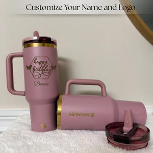 Gold laser engraved Stanley style 40oz tumbler featuring a personalized name, designed as a unique birthday gift for women. Includes a flip straw lid and sturdy handle for convenience and daily use. This insulated tumbler keeps beverages hot or cold for extended periods and offers a stylish and modern look, making it a thoughtful and practical personalized gift.